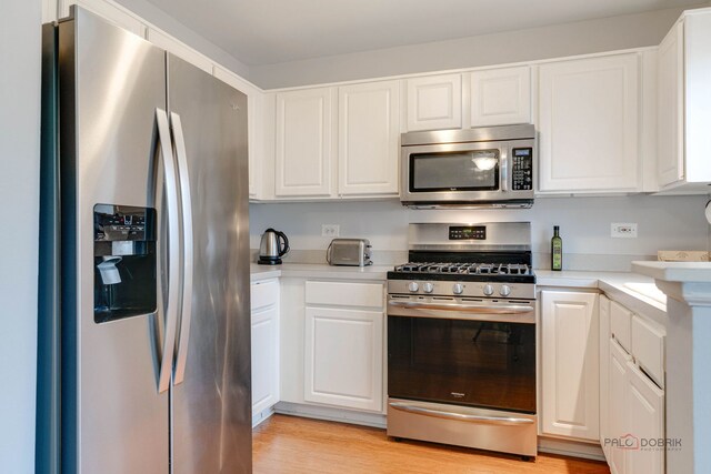 4553 W Hill Ave Unit 3, Waukegan, IL 60085 - kitchen featuring stainless steel appliances, light countertops, and white cabinets
