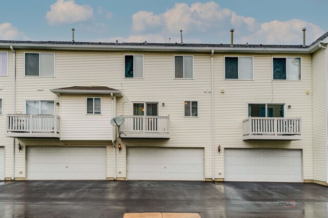 4553 W Hill Ave Unit 3, Waukegan, IL 60085 - rear view of property featuring an attached garage and driveway