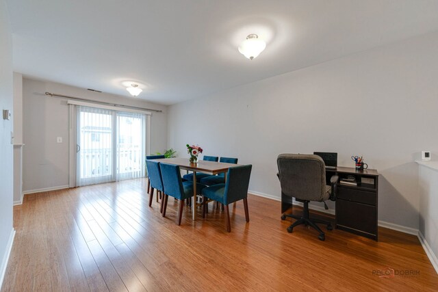4553 W Hill Ave Unit 3, Waukegan, IL 60085 - dining room featuring wood finished floors and baseboards