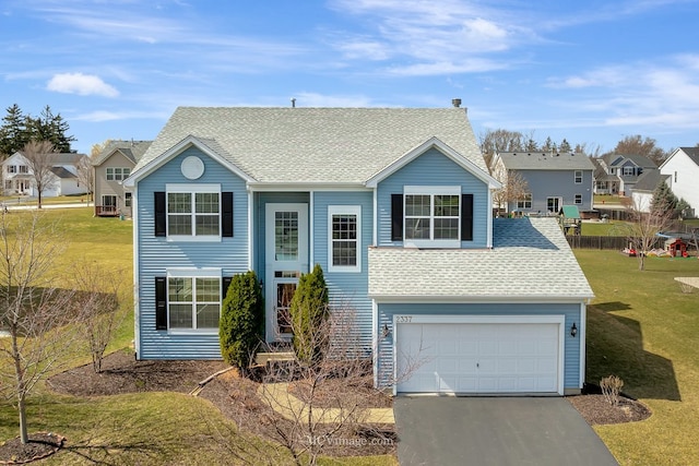 view of front of property with an attached garage, roof with shingles, asphalt driveway, and a residential view