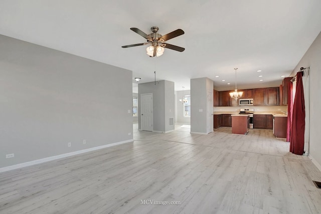 unfurnished living room featuring a chandelier, a ceiling fan, light wood-type flooring, recessed lighting, and baseboards