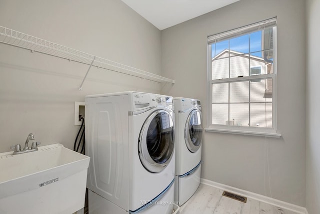 washroom featuring independent washer and dryer and baseboards