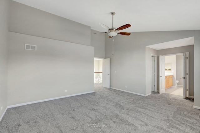 carpeted empty room with a ceiling fan, baseboards, and high vaulted ceiling