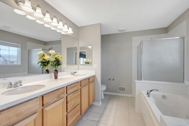 full bathroom featuring tile patterned floors, toilet, a garden tub, double vanity, and a shower stall