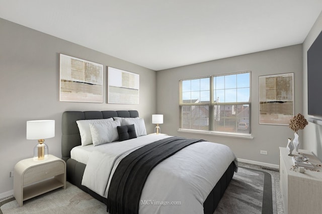 bedroom with light carpet and baseboards