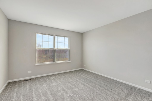 empty room with carpet floors and baseboards