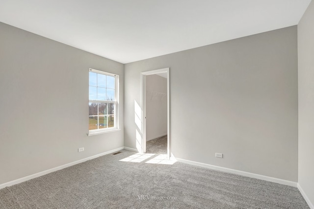 spare room with carpet flooring and baseboards