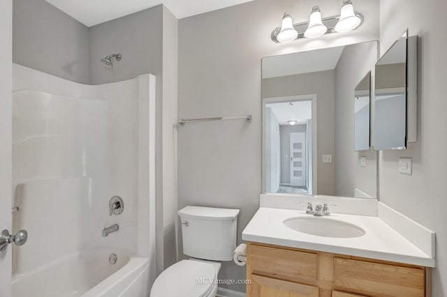 bathroom featuring bathtub / shower combination, vanity, and toilet