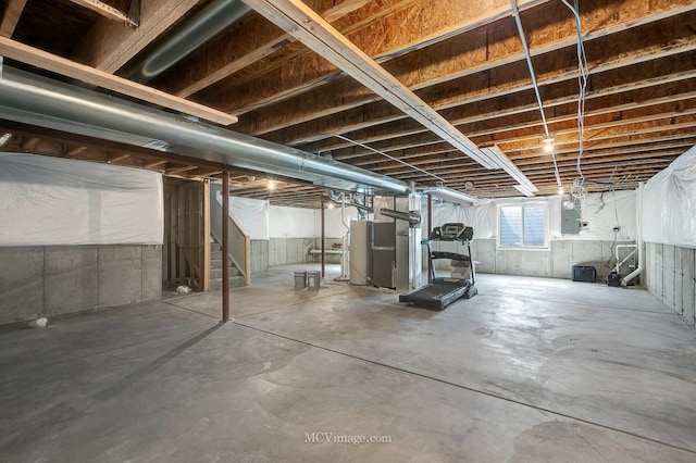 basement with water heater, electric panel, and stairway