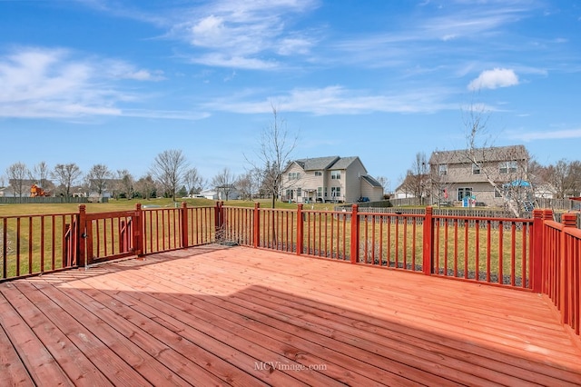deck with a residential view and a fenced backyard