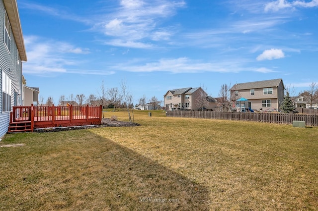 view of yard with a residential view and a wooden deck