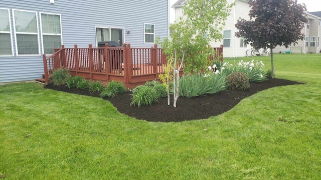 view of grassy yard featuring a deck