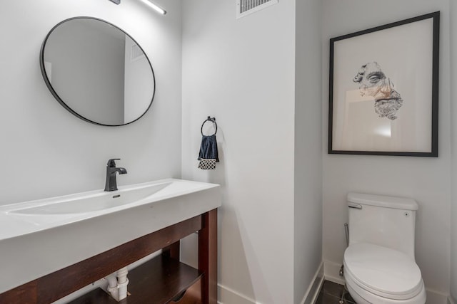 1522 W Wolfram St, Chicago, IL 60657 - half bathroom featuring toilet, baseboards, visible vents, and vanity