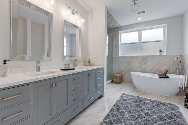 1522 W Wolfram St, Chicago, IL 60657 - bathroom with double vanity, visible vents, a sink, and marble finish floor