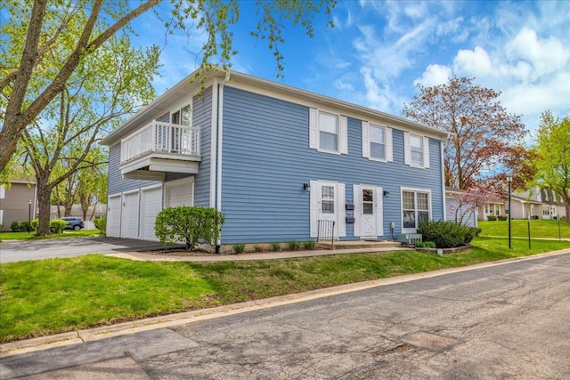1330 Woodcutter Ln, Wheaton, IL 60189 - view of front of property featuring a balcony, driveway, an attached garage, and a front lawn