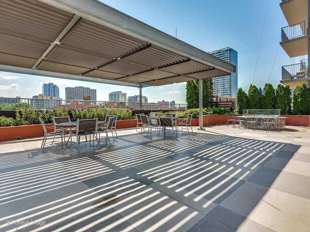 view of patio / terrace featuring outdoor dining area and a city view