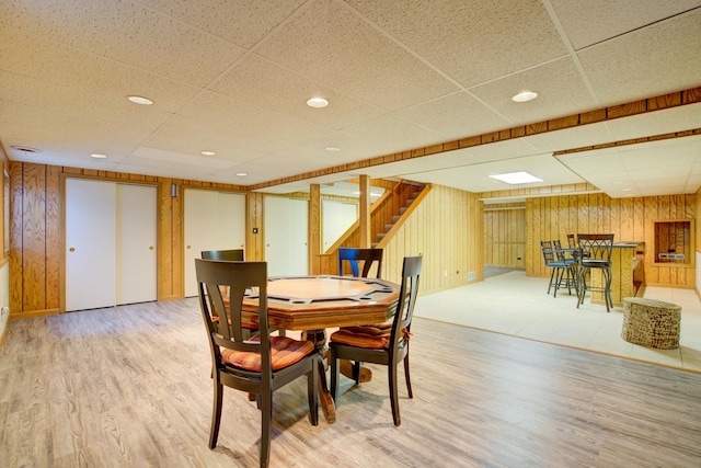 809 S Charles Ave, Naperville, IL 60540 - dining space featuring light wood-style flooring, a paneled ceiling, and stairs