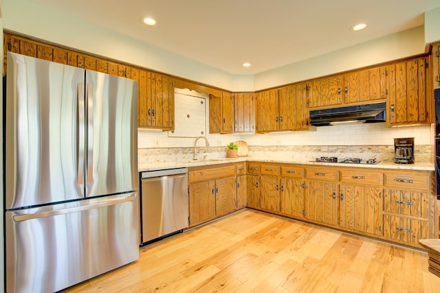 809 S Charles Ave, Naperville, IL 60540 - kitchen featuring under cabinet range hood, brown cabinets, a sink, backsplash, and stainless steel appliances