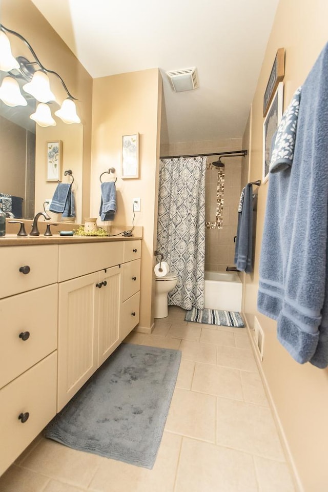 full bath featuring vanity, toilet, tile patterned floors, visible vents, and shower / bath combo