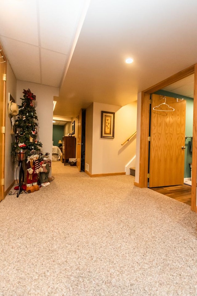 finished below grade area with carpet flooring, baseboards, stairway, and recessed lighting