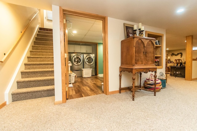 stairs with carpet flooring, baseboards, recessed lighting, a drop ceiling, and washer and clothes dryer