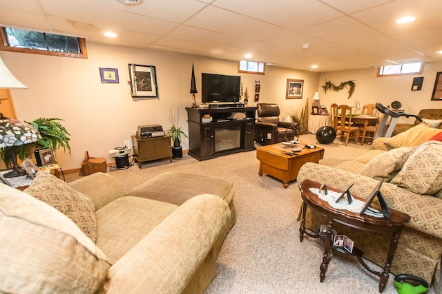 living room featuring a drop ceiling, recessed lighting, and carpet