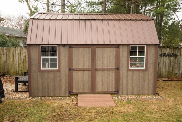 view of shed featuring fence