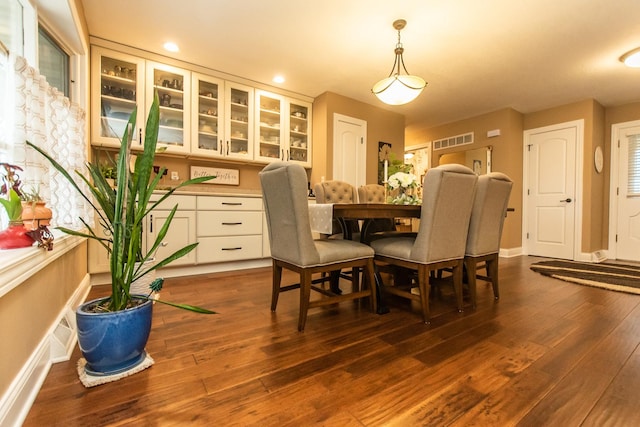 dining space with recessed lighting, baseboards, visible vents, and dark wood finished floors