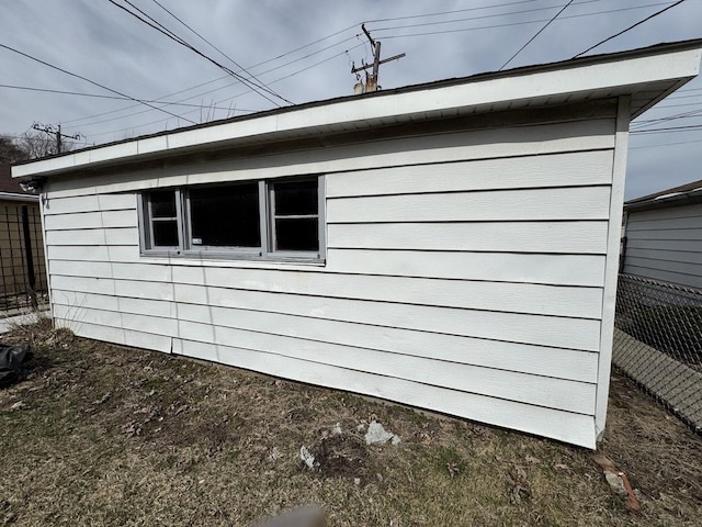 view of side of property featuring fence