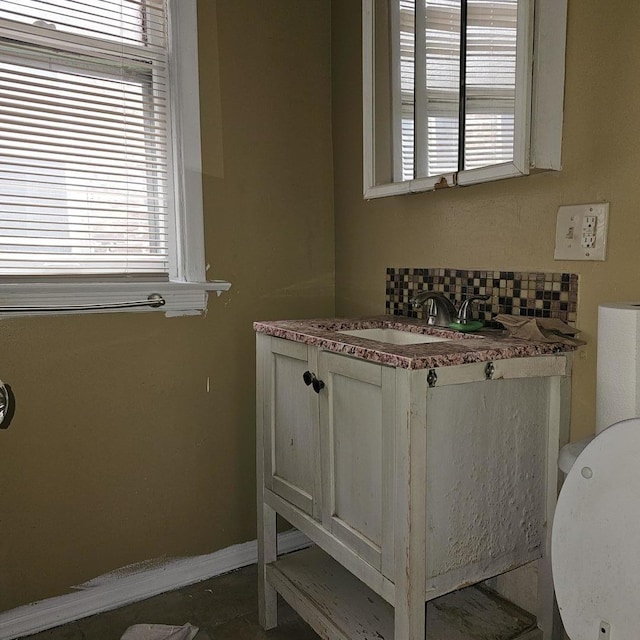 2251 S Kirkland Ave, Chicago, IL 60623 - bathroom featuring baseboards, vanity, and tasteful backsplash