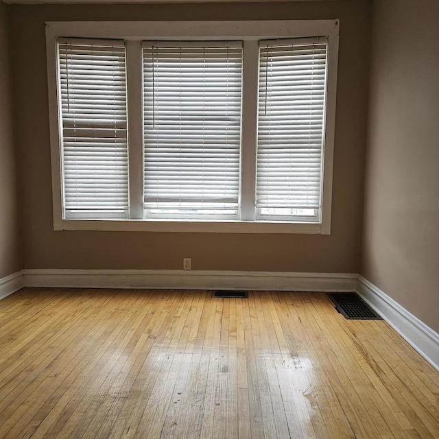 2251 S Kirkland Ave, Chicago, IL 60623 - empty room with hardwood / wood-style flooring, baseboards, and visible vents