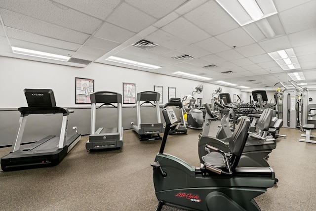 gym featuring visible vents and a paneled ceiling