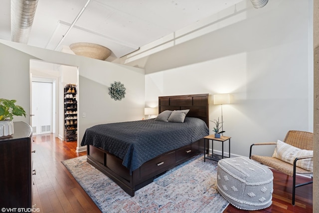 bedroom with wood-type flooring, baseboards, and visible vents