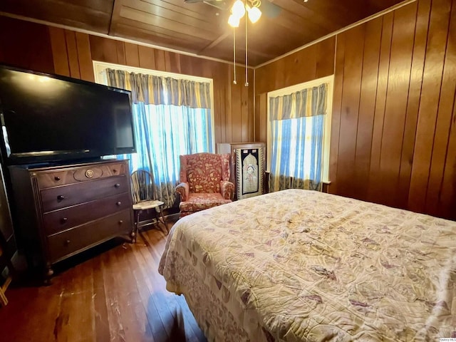 bedroom featuring crown molding, wood walls, wood ceiling, and hardwood / wood-style flooring