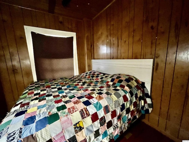 bedroom with wood walls