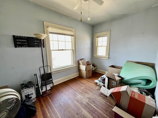 miscellaneous room with baseboards, ceiling fan, and wood-type flooring