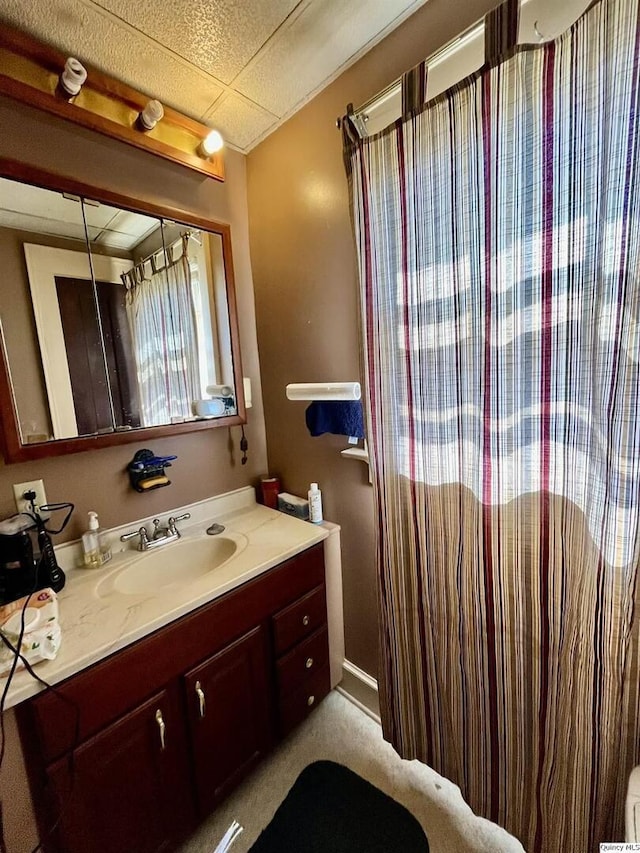 bathroom featuring a drop ceiling and vanity