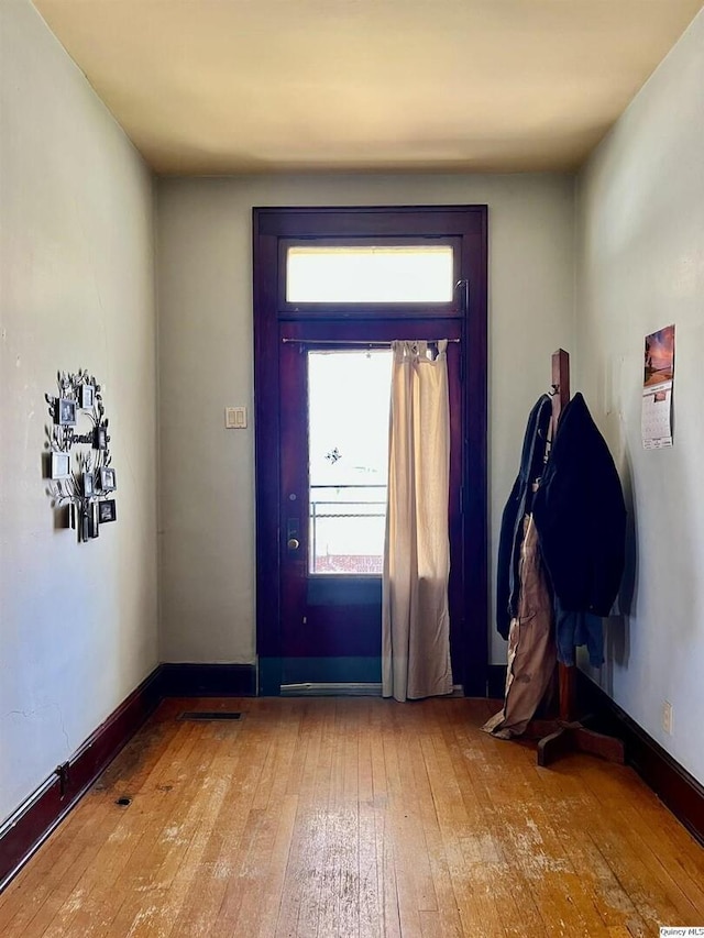 entrance foyer with baseboards and hardwood / wood-style flooring