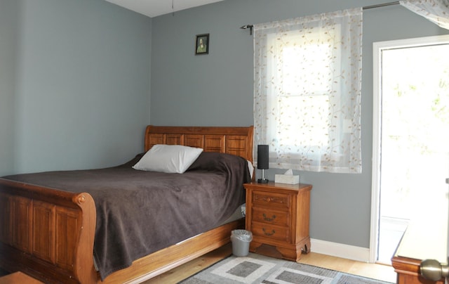 bedroom with baseboards and wood finished floors