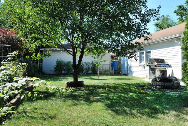 view of yard with a fire pit