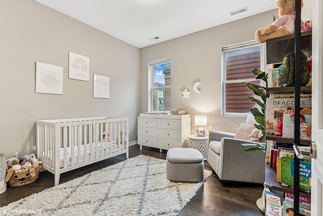 1841 N California Ave Unit 3A, Chicago, IL 60647 - bedroom with dark wood-style flooring, a nursery area, and baseboards
