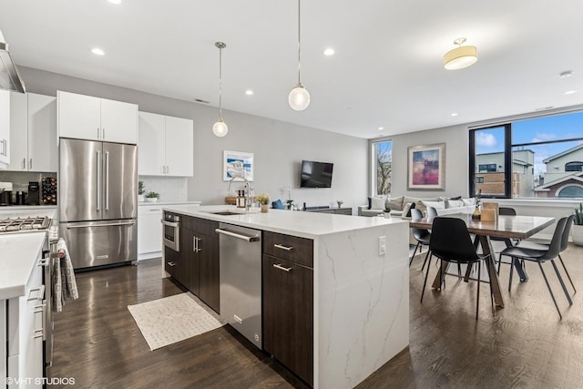 1841 N California Ave Unit 3A, Chicago, IL 60647 - kitchen featuring appliances with stainless steel finishes, recessed lighting, a sink, dark wood-type flooring, and a kitchen island with sink