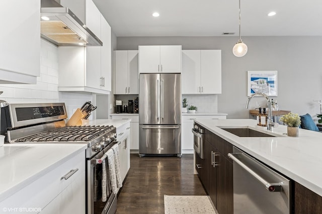 1841 N California Ave Unit 3A, Chicago, IL 60647 - kitchen featuring stainless steel appliances, wall chimney range hood, a sink, dark wood-style floors, and recessed lighting