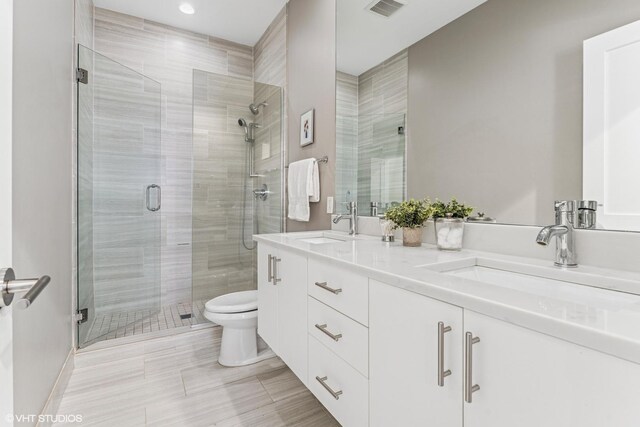 1841 N California Ave Unit 3A, Chicago, IL 60647 - full bathroom featuring double vanity, a shower stall, and toilet