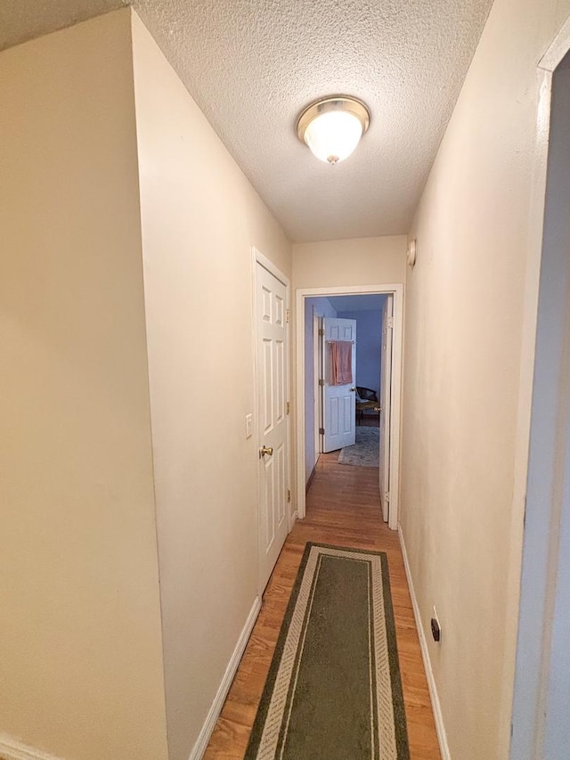 5500 Lincoln Ave Ave Unit 118E, Morton Grove, IL 60053 - hall featuring light wood finished floors and a textured ceiling