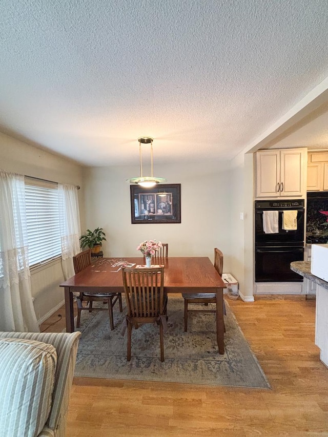 5500 Lincoln Ave Ave Unit 118E, Morton Grove, IL 60053 - dining area with a textured ceiling and light wood finished floors