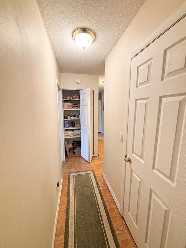 5500 Lincoln Ave Ave Unit 118E, Morton Grove, IL 60053 - hallway featuring light wood finished floors and a textured ceiling