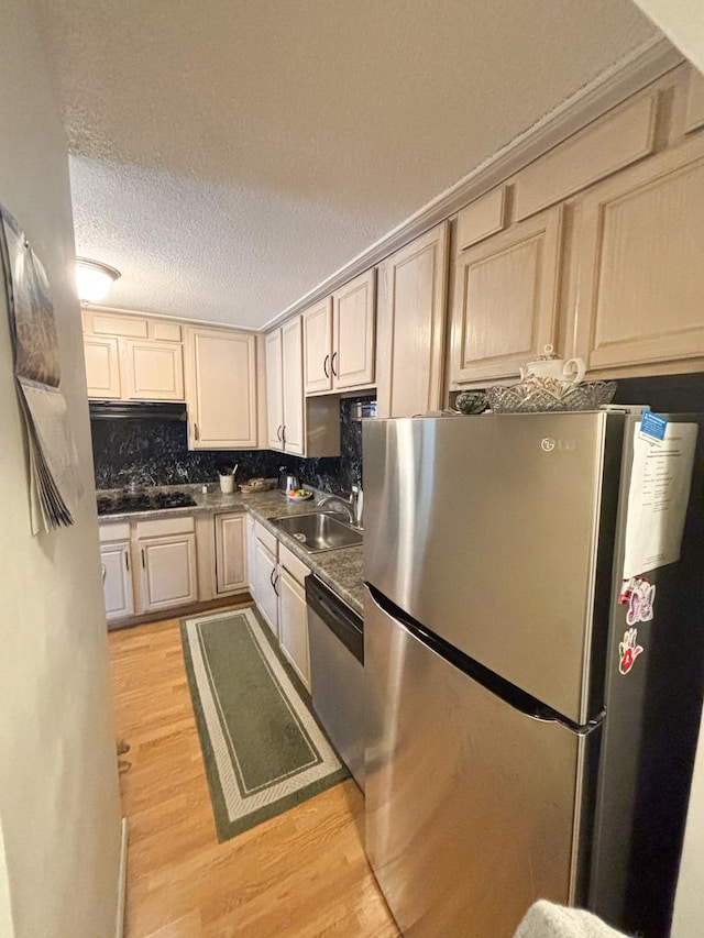 5500 Lincoln Ave Ave Unit 118E, Morton Grove, IL 60053 - kitchen with appliances with stainless steel finishes, light wood-style floors, a textured ceiling, dark countertops, and tasteful backsplash