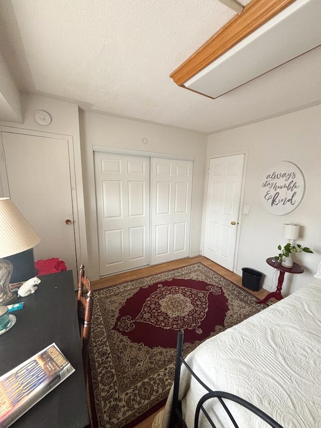 5500 Lincoln Ave Ave Unit 118E, Morton Grove, IL 60053 - bedroom with a closet and a textured ceiling