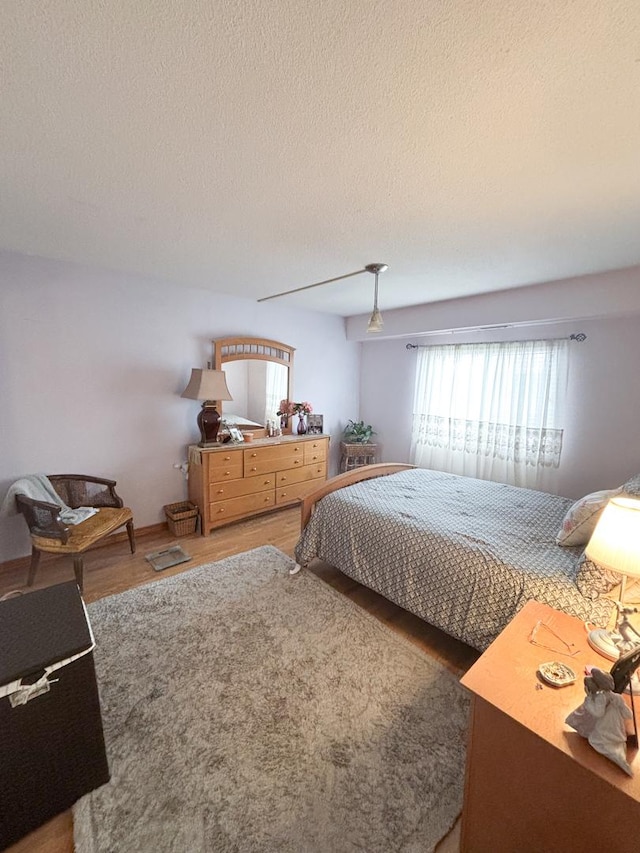 5500 Lincoln Ave Ave Unit 118E, Morton Grove, IL 60053 - bedroom with wood finished floors, a textured ceiling, and a ceiling fan